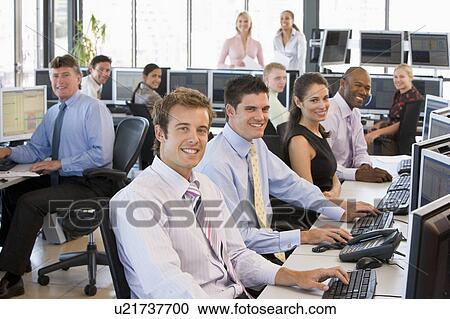 Stock Image - View Of Busy Stock Traders Office. Fotosearch