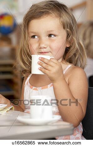 Stock Photography - Young Boy Having Tea at Montessori/Pre-School. Fotosearch