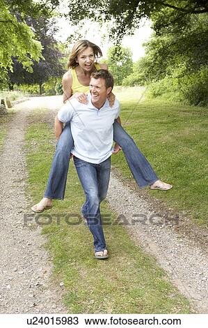 Young couple having fun in countryside View Large Photo Image Stock Image - Young couple having fun in countryside. Fotosearch