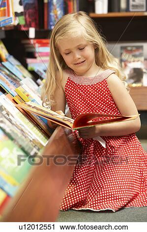 Young girl in bookshop View Large Photo Image Stock Image - Young girl in bookshop. Fotosearch