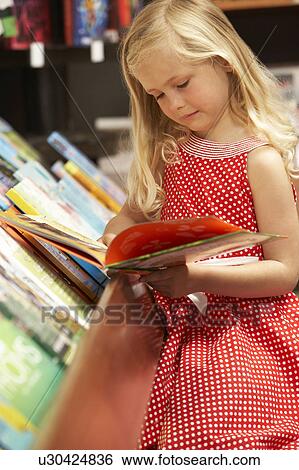 Young girl in bookshop View Large Photo Image Stock Photograph - Young girl in bookshop. Fotosearch