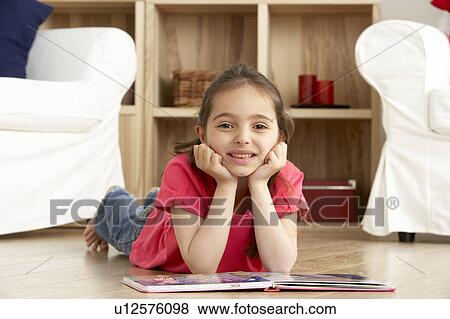 Young Girl Reading Book at Home View Large Photo Image Stock Photo - Young Girl Reading Book at Home. Fotosearch