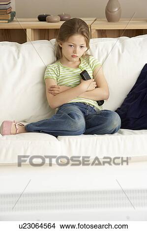 Picture - Young Girl Watching Television at Home. Fotosearch