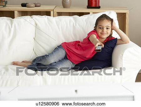 Stock Photograph - Young Girl Watching Television at Home. Fotosearch