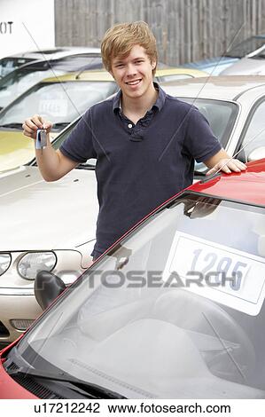 Young man collecting new car View Large Photo Image Stock Image - Young man collecting new car. Fotosearch