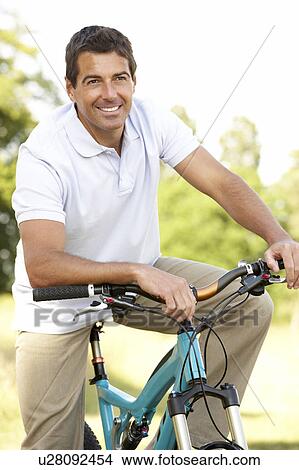 Young man riding bike in countryside View Large Photo Image Picture - Young man riding bike in countryside. Fotosearch
