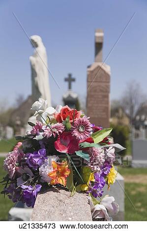 Stock Image - Bouquet of artificial flowers at a cemetery; Laval, Quebec, Canada. Fotosearch