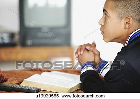 Stock Photography - Child praying. Fotosearch
