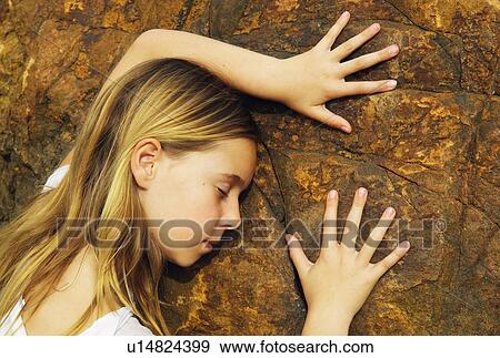 Stock Photo - Child touching a rock. Fotosearch