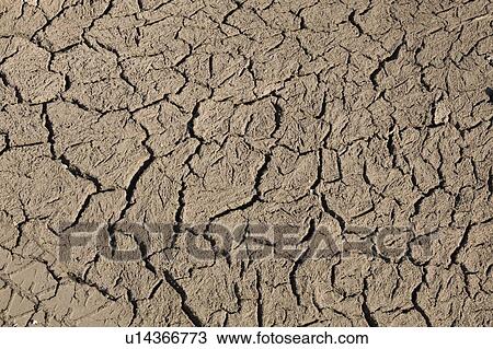 Stock Image - Close-up of cracked and dried ground. Fotosearch
