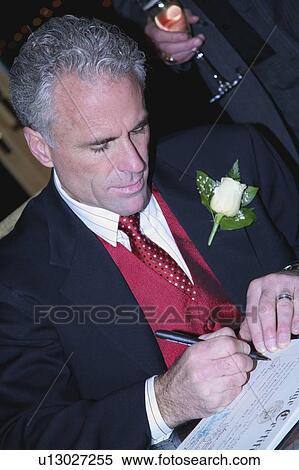 Stock Photography - Groom writing signature. Fotosearch
