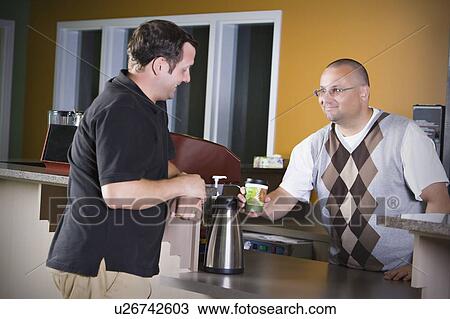 Stock Image - Man pouring coffee. Fotosearch