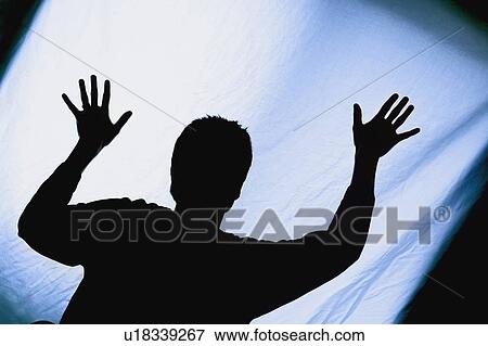 Silhouette of a man with arms raised View Large Photo Image Stock Photo - Silhouette of a man with arms raised. Fotosearch