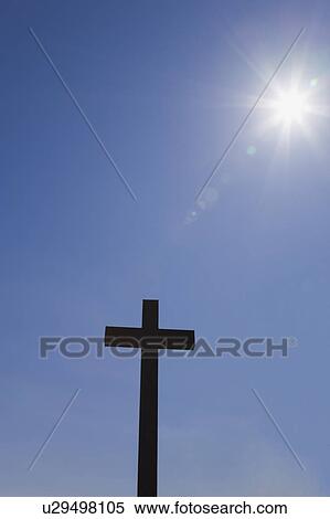 Stock Photography - Silhouetted cross and sunburst. Fotosearch