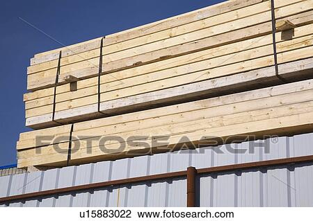 Stock Image - Stacks of tied lumber; Laval, Quebec, Canada. Fotosearch
