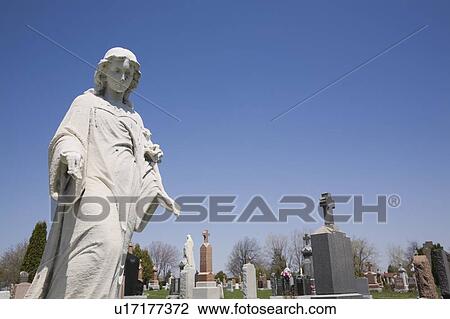 Statue and headstones in cemetery; Laval, Quebec, Canada View Large Photo Image Stock Image - Statue and headstones in cemetery; Laval, Quebec, Canada. Fotosearch