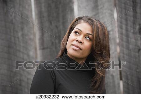 Woman in black, looking up View Large Photo Image Stock Image - Woman in black, looking up. Fotosearch
