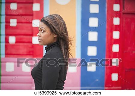 Stock Photography - Woman standing in front of a mural. Fotosearch