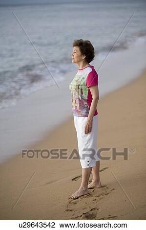 Woman standing on the beach, Maui, Hawaii, USA View Large Photo Image Stock Image - Woman standing on the beach, Maui, Hawaii, USA. Fotosearch