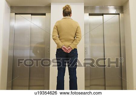 Woman waiting for an elevator View Large Photo Image Stock Photograph - Woman waiting for an elevator. Fotosearch