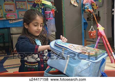 A girl taking something out of her bag View Large Photo Image Stock Photo - A girl taking something out of her bag. Fotosearch