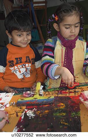 A little boy smiling while looking at a painting View Large Photo Image Stock Image - A little boy smiling while looking at a painting. Fotosearch