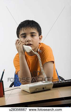 Boy talking on the phone View Large Photo Image Stock Photo - Boy talking on the phone. Fotosearch