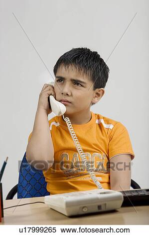 Stock Photography - Boy talking on the phone. Fotosearch