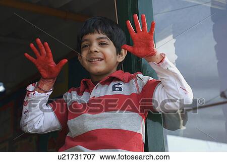 Stock Photo - Boy with paint on hands. Fotosearch