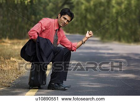 Businessman seeking a lift View Large Photo Image Stock Image - Businessman seeking a lift. Fotosearch
