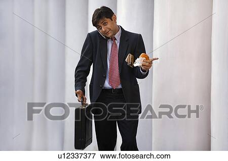 Businessman talking on the mobile phone View Large Photo Image Stock Photo - Businessman talking on the mobile phone. Fotosearch