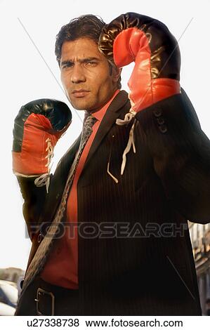 Businessman wearing boxing gloves View Large Photo Image Stock Photo - Businessman wearing boxing gloves. Fotosearch