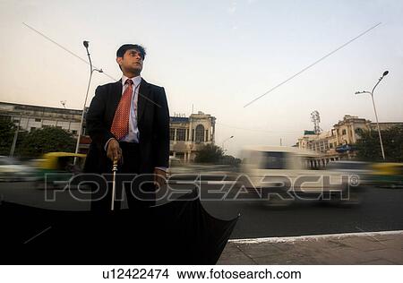 Businessman with an umbrella View Large Photo Image Picture - Businessman with an umbrella. Fotosearch