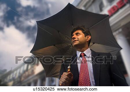 Stock Photography - Businessman with an umbrella. Fotosearch