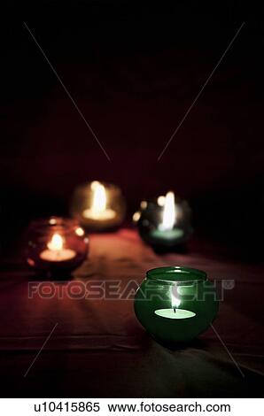 Stock Photography - Candles in colourful glass jars. Fotosearch