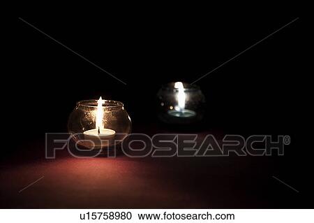 Stock Image - Candles in glass jars. Fotosearch