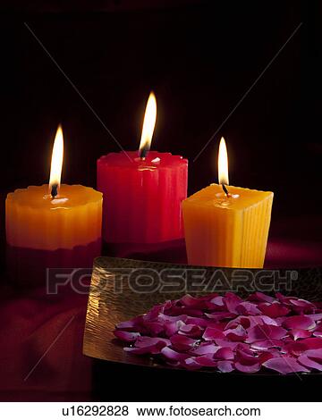 Candles with flower petals View Large Photo Image Stock Photo - Candles with flower petals. Fotosearch