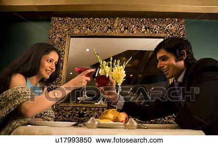 Stock Image - Couple enjoying a meal. Fotosearch