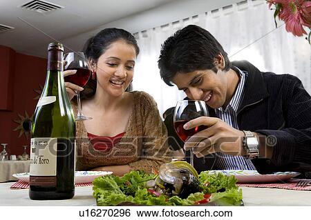 Couple enjoying a meal View Large Photo Image Stock Photograph - Couple enjoying a meal. Fotosearch