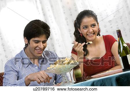 Stock Photograph - Couple enjoying a meal . Fotosearch