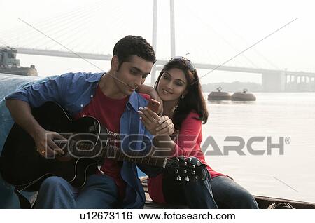 Stock Photograph - Couple looking at a phone. Fotosearch