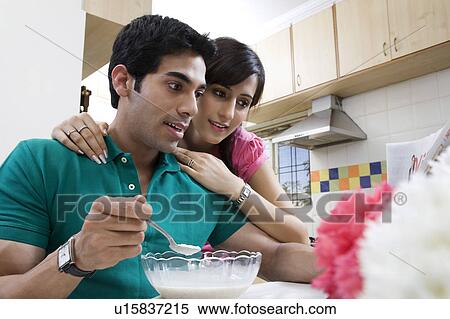 Couple looking at the morning newspaper View Large Photo Image Stock Photography - Couple looking at the morning newspaper. Fotosearch
