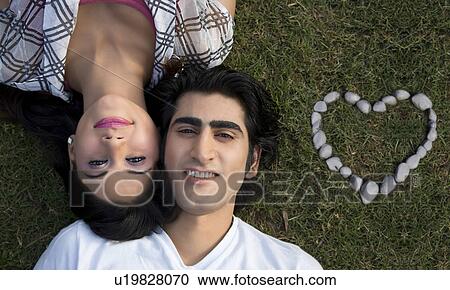 Couple lying down together. View Large Photo Image Stock Image - Couple lying down together.. Fotosearch