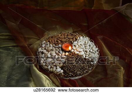 Different nuts and diya View Large Photo Image Stock Image - Different nuts and diya. Fotosearch