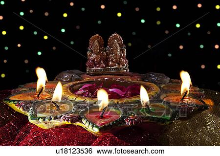 Diyas around idols View Large Photo Image Stock Photograph - Diyas around idols. Fotosearch