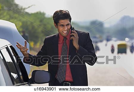 Executive stranded with a broken down car View Large Photo Image Stock Image - Executive stranded with a broken down car. Fotosearch