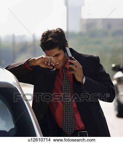 Picture - Executive talking on the mobile phone. Fotosearch