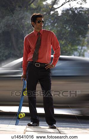 Stock Photograph - Executive with a skateboard. Fotosearch