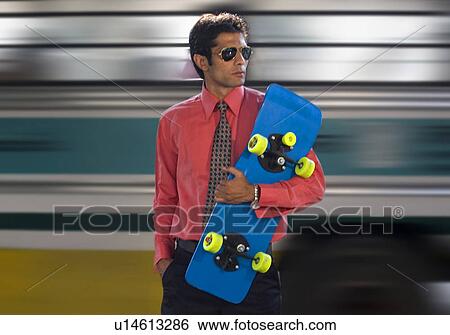 Stock Photograph - Executive with a skateboard. Fotosearch