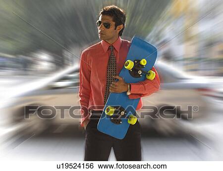 Stock Photograph - Executive with a skateboard. Fotosearch